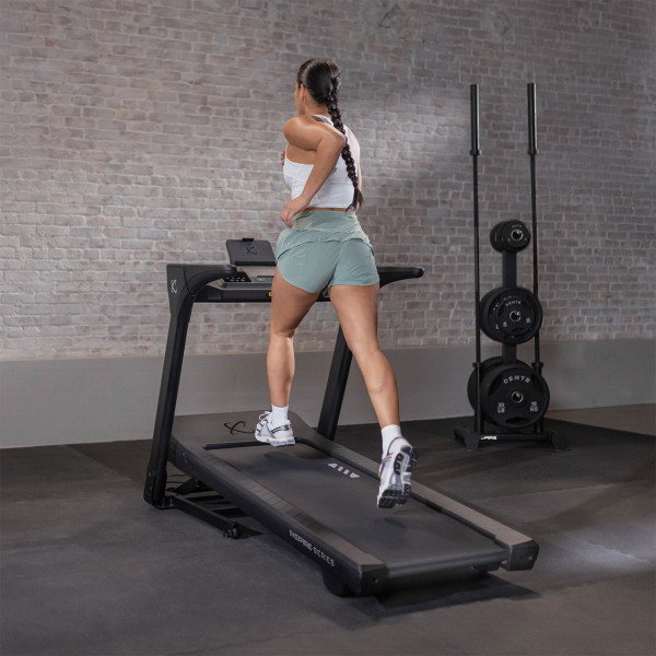 Rear view of a person running on the Inspire Fitness Series T4 Treadmill