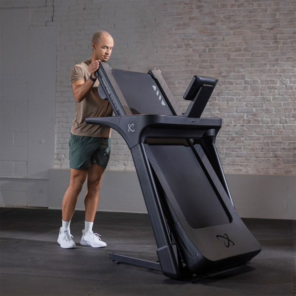 User folding the Inspire Fitness Series T4S Treadmill