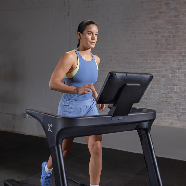 User running on the Inspire Fitness Series T5 Treadmill front view