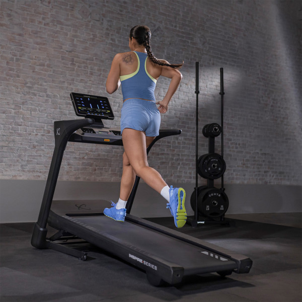Rear view of user running on the Inspire Fitness Series T5 Treadmill