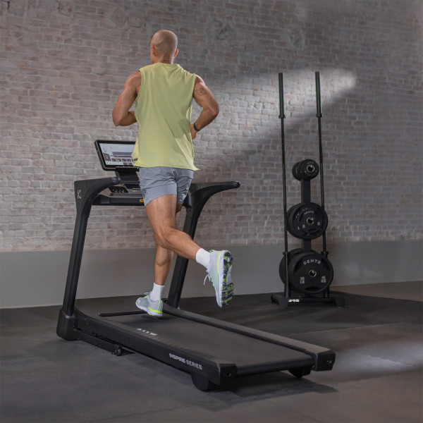Rear view of user running on the Inspire Fitness Series T5S Treadmill