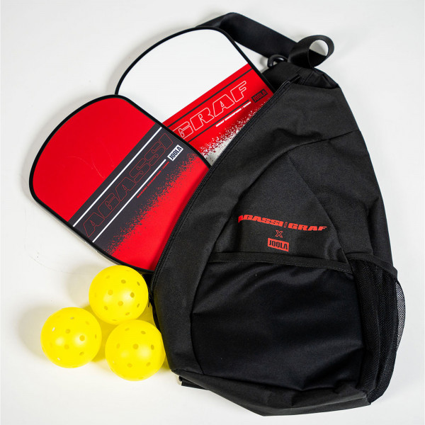Open carry bag containing the Agassi Champion Pickleball Paddle, Graf Champion Pickleball Paddle, and pickleballs.
