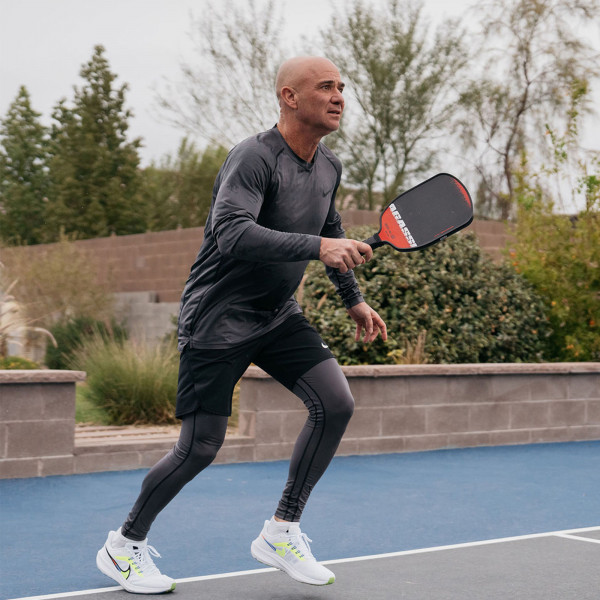 Person playing pickleball on court with the JOOLA Agassi Edge 16mm Pickleball Paddle.