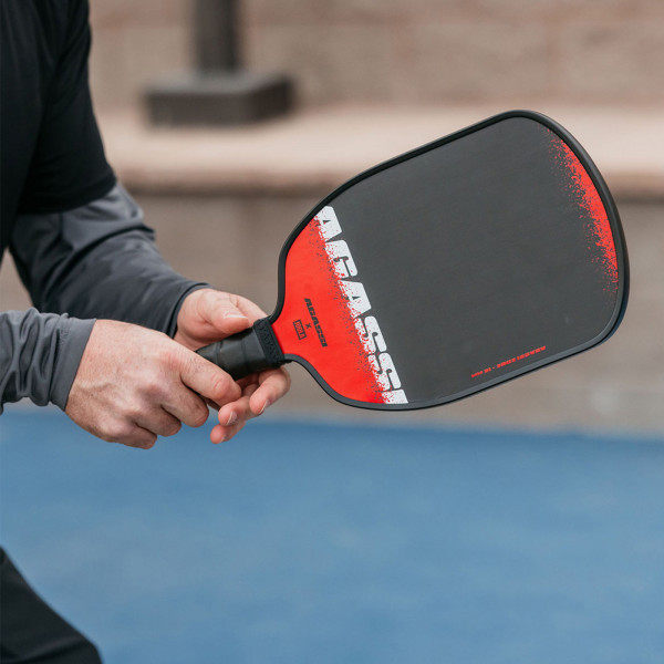 Hand holding the JOOLA Agassi Edge 16mm Pickleball Paddle.