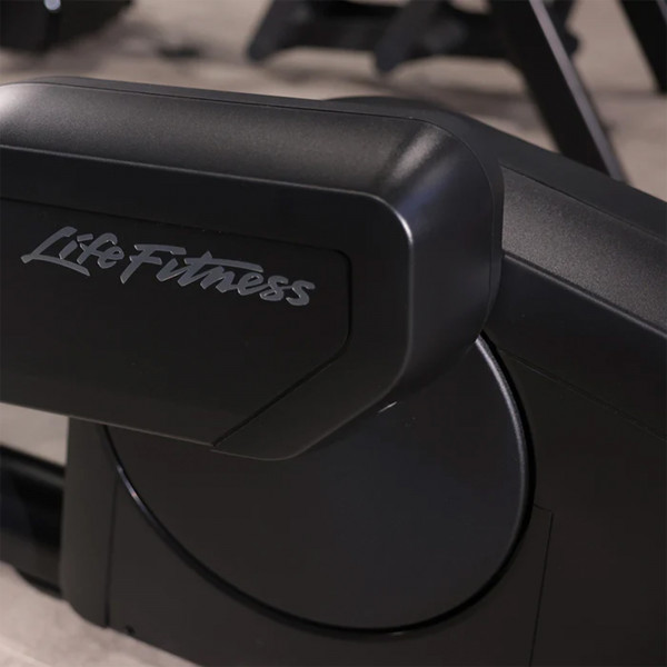 Close-up view of the flywheel housing with the Life Fitness logo on the Club Series Plus Elliptical Cross Trainer.