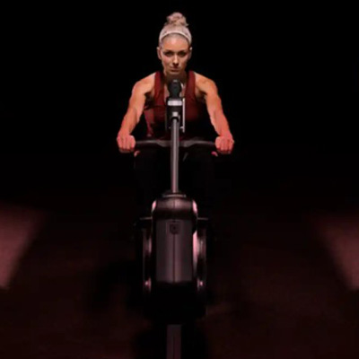 Front view of a model rowing on the Life Fitness Heat Performance Row