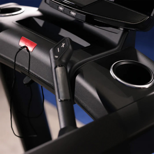 Close-up of the handrail controls and cup holders on the Life Fitness Club Series Plus Treadmill.

