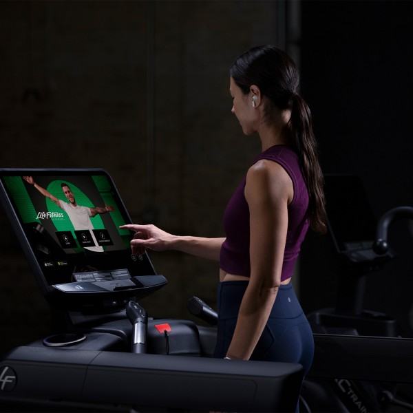 Exerciser starting workout on the Life Fitness Integrity+ Treadmill