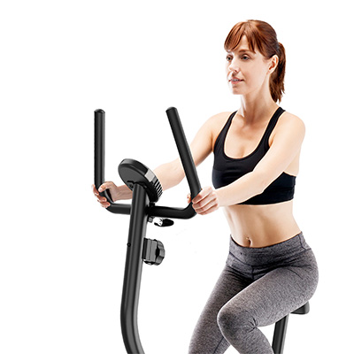 Close-up of a model using the handlebars on the Marcy Arrow Compact Upright Exercise Bike during exercise 