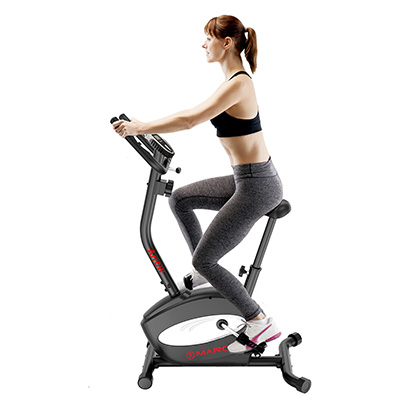 Model exercising on the Marcy Arrow Compact Upright Exercise Bike in a seated riding position