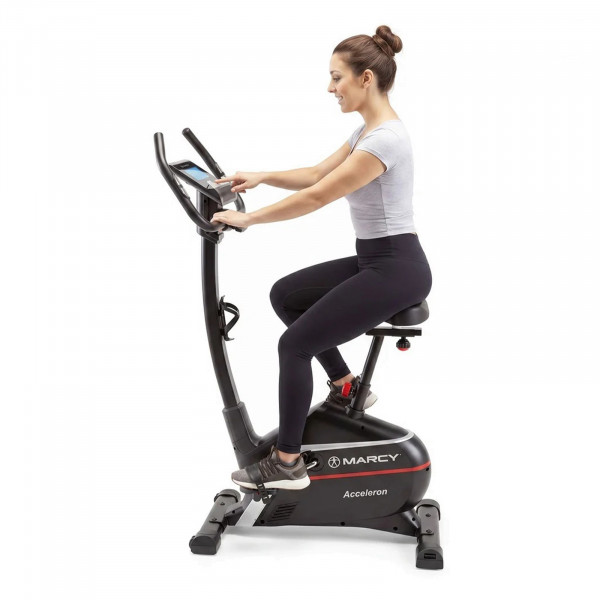 Model adjusting the console display on the Marcy Acceleron Electro Magnetic Exercise Bike