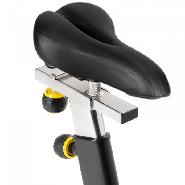 Padded ergonomic bike seat with adjustable positioning on the Marcy 7038 Studio Bike