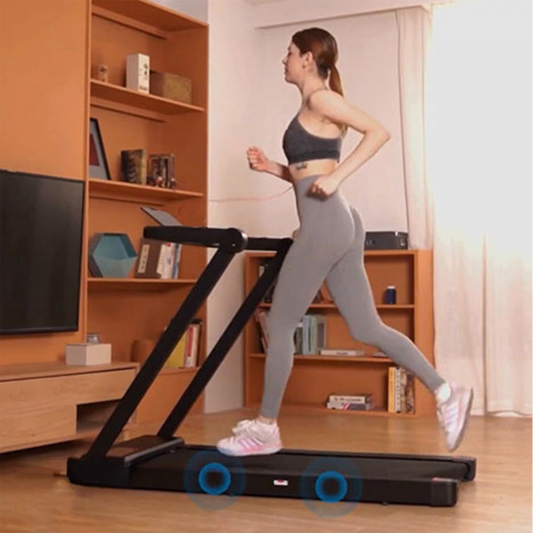 Model running on the Marcy Walk N Run Walking Pad Treadmill with shock absorption system