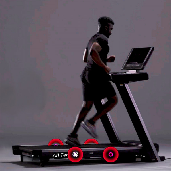 Model running on the cushioned deck of the Marcy All Terrain Power Fold Treadmill