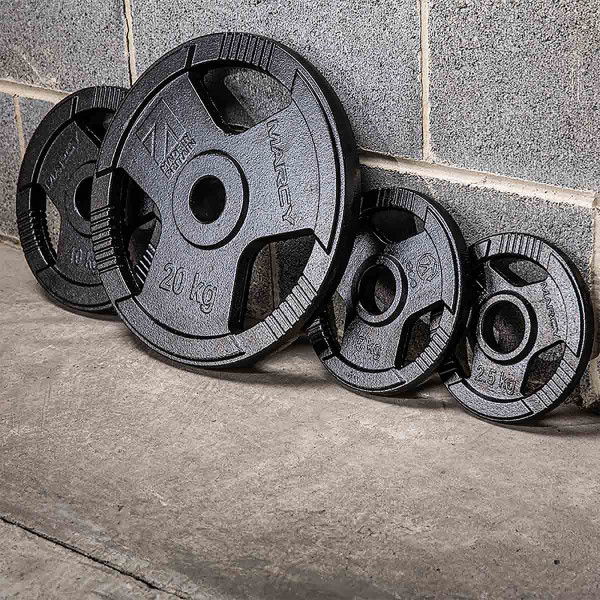 Lifestyle image of the Marcy Eco Weight Plates against a wall