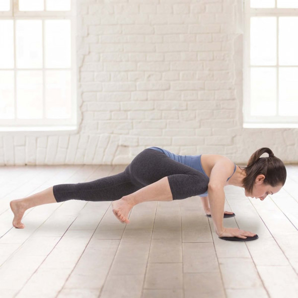 Model performing a mountain climber with the Merrithew Sliding Mobility Discs set of 2