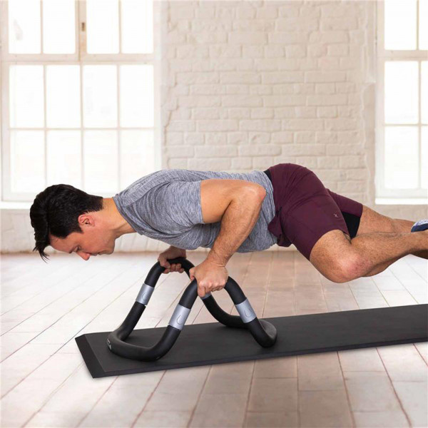 Model performing push-ups on the black Merrithew Eco-Lux Imprint Mat