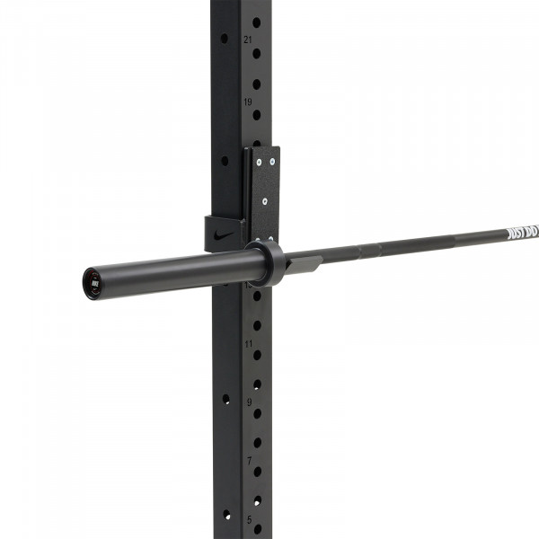 The Nike Strength Premium Barbell 15kg in black mounted on a squat rack.