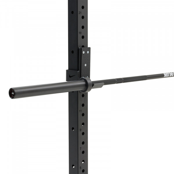 The Nike Strength Premium Barbell 20kg in black mounted on a squat rack.