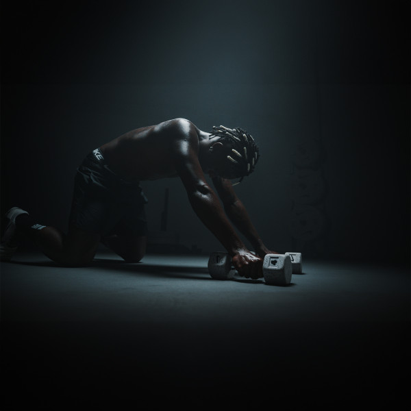 Lifestyle image of Vinni Jr holding a grind dumbbell