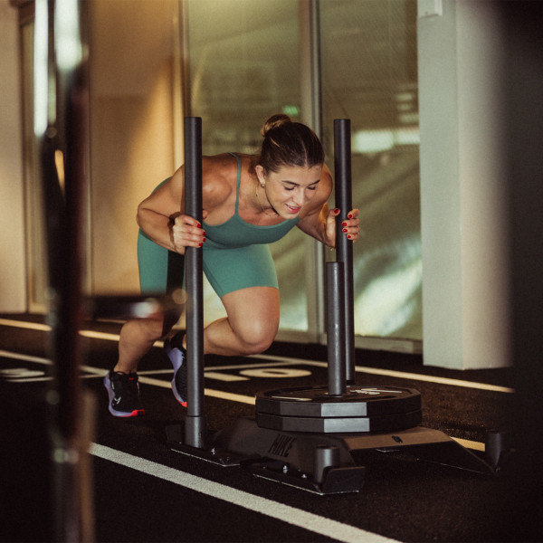 Lifestyle image of a model using the Nike Strength Sled