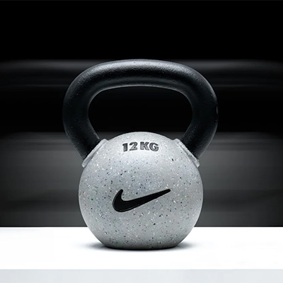 Photograph of the Nike Strength Rubber Coated Kettlebell. There is a distortion effect in the background.