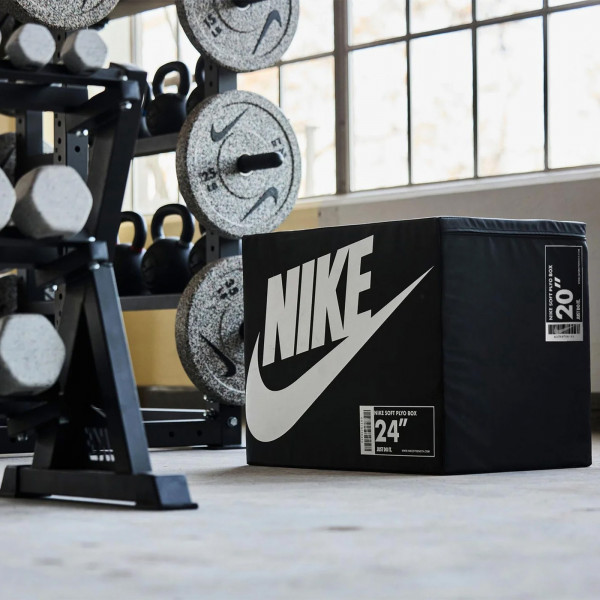 Nike Strength Soft Plyo Box in black placed in training space with weights