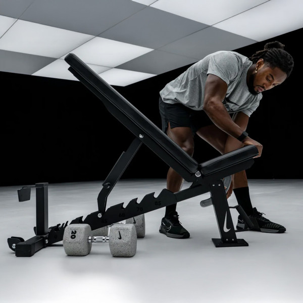 Person adjusting the Nike Strength Adjustable Weight Bench