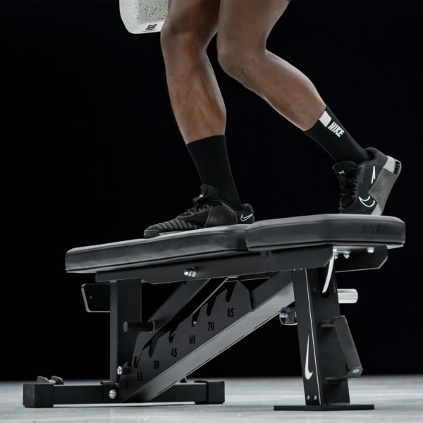Person stepping onto the Nike Strength Adjustable Weight Bench