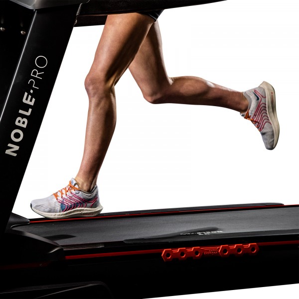 Side view of a user actively running on the NoblePro Elite E10i Treadmill.
