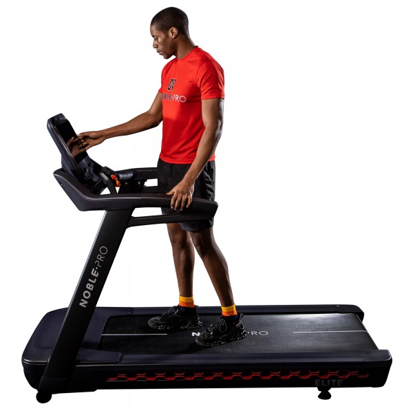 User adjusting the settings on the NoblePro Elite E10i Treadmill.