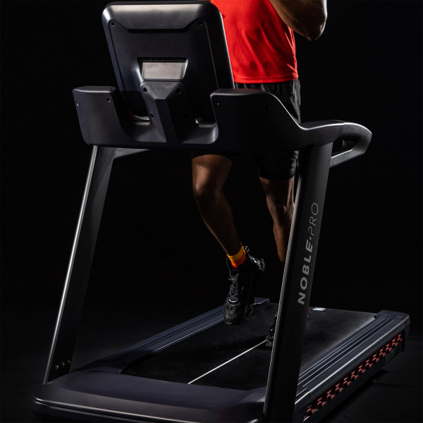 Front close-up of the model running on the NoblePro Elite E10i Treadmill