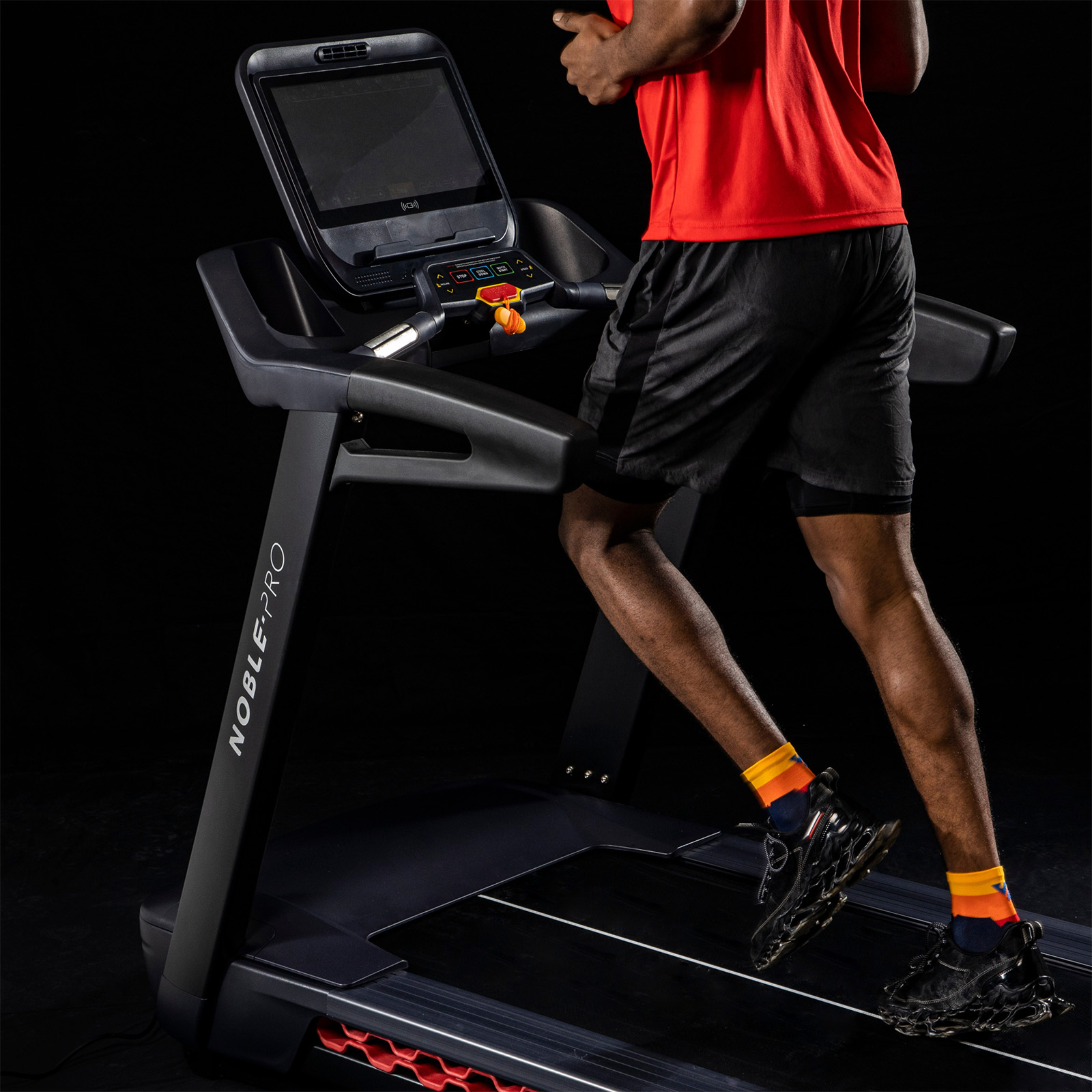 Rear close-up of the model running on the NoblePro Elite E10i Treadmill 