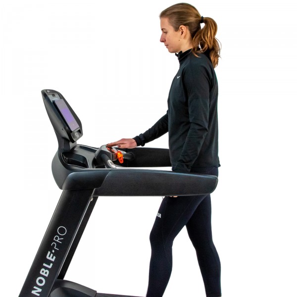 User setting up the NoblePro Elite E8.0 Treadmill.