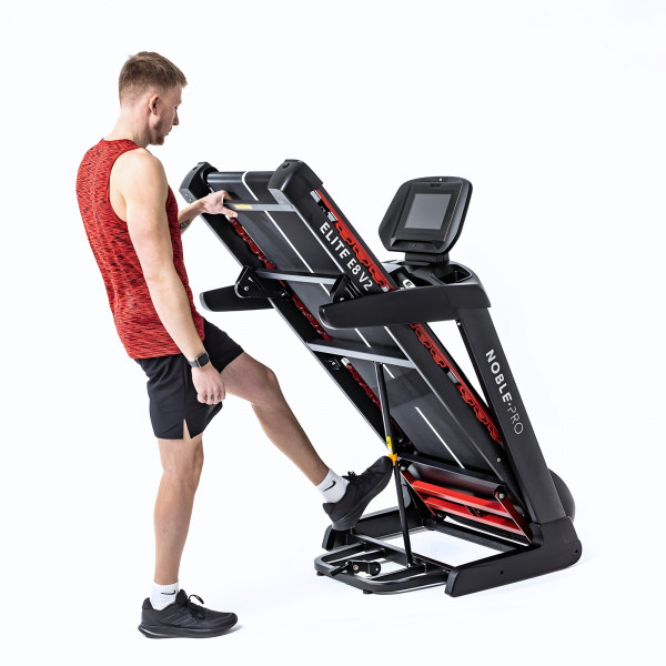Model folding the NoblePro Elite E8ix Treadmill for storage