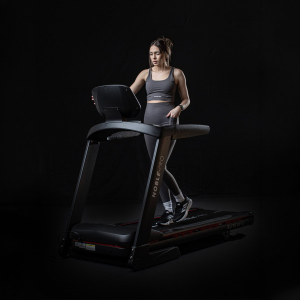Model walking on the NoblePro Elite E8ix Treadmill from the front angle