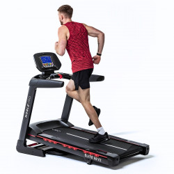 Angled view of a person running on the NoblePro Elite E8s Treadmill at an incline.
