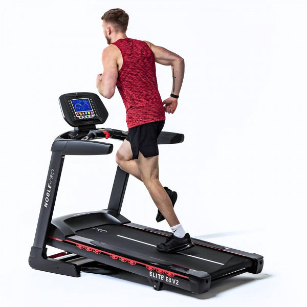 Angled view of a person running on the NoblePro Elite E8s Treadmill at an incline.