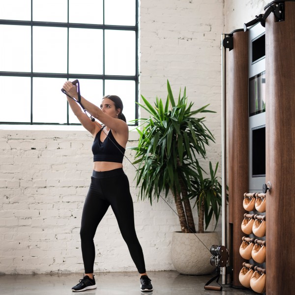 Another perspective of a person having an active training session with the NOHRD Wall Compact.