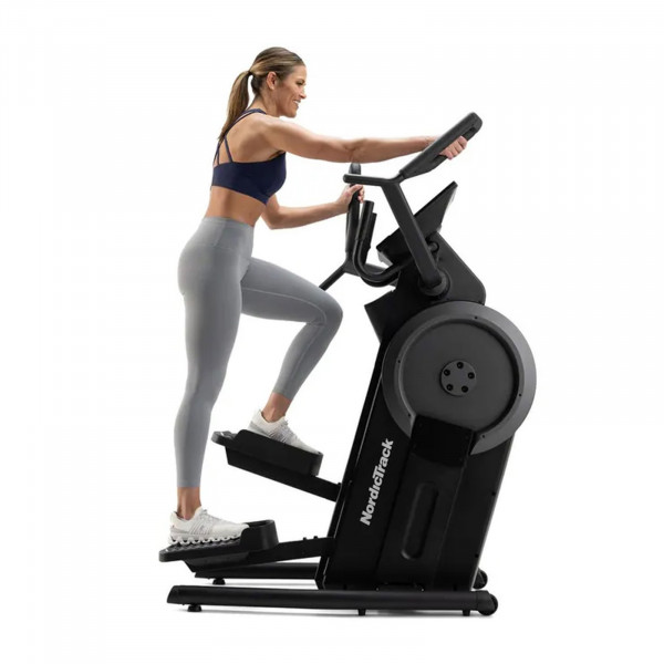 Side view of a person stepping on the NordicTrack Step Climber