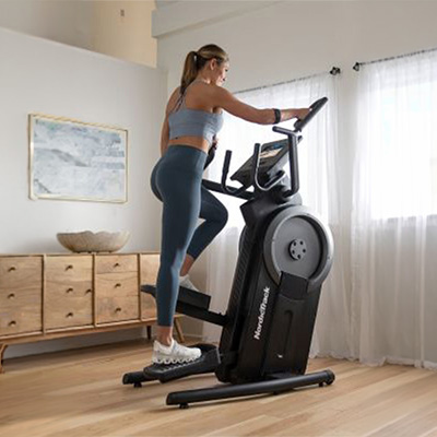 Side view of a user performing step climbing exercise on the NordicTrack Step Climber 