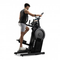 Side view of a person stepping on the NordicTrack Step Climber XL