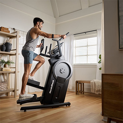 Side view of a user performing step climbing exercise on the NordicTrack Step Climber XL 