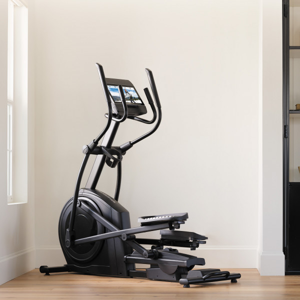Side angled view of the NordicTrack AirGlide 14i Elliptical in a home setting