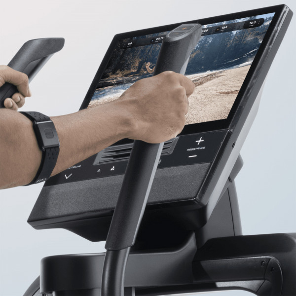 Angled closeup of the NordicTrack AirGlide 16 Elliptical handlebars and touchscreen controls during a workout