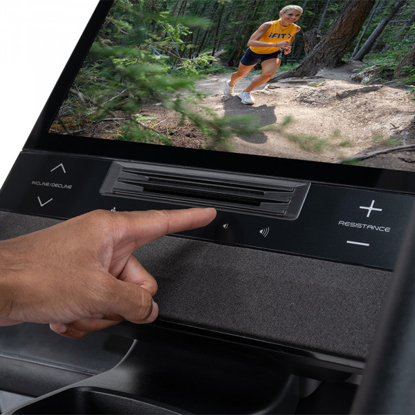 Model adjusting NordicTrack X16 Elliptical console controls and speaker panel
