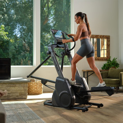 Model using NordicTrack X16 Elliptical while stepping uphill on an incline
