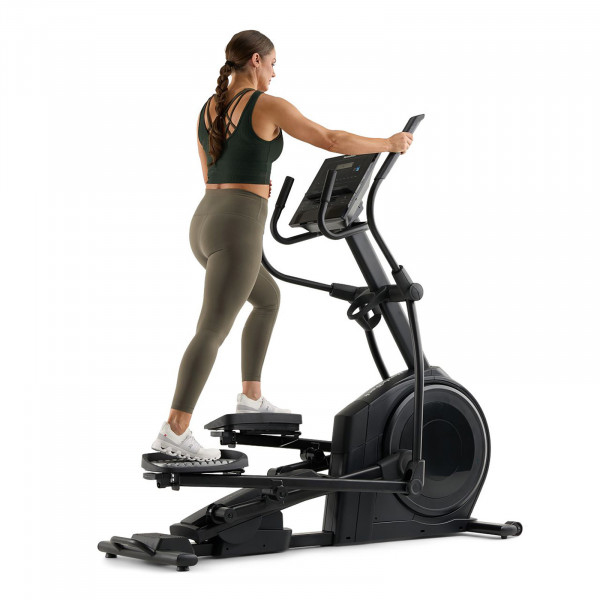 Model exercising on the NordicTrack AirGlide LE Elliptical against a white background