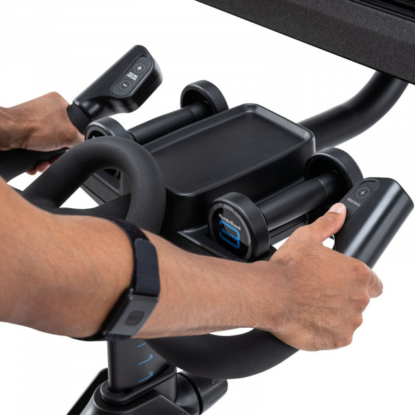 Closeup of the handlebar controls on the NordicTrack X24 Bike with resistance buttons