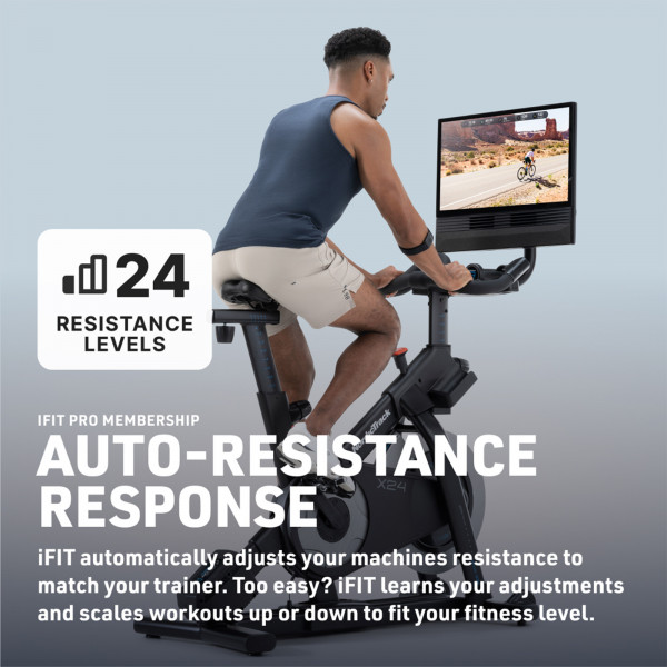 Rear angled view of a model cycling on the NordicTrack X24 Bike with resistance feature overlay